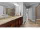 Double vanity bathroom with granite countertops, tile floor, and a separate tiled shower at 2213 Normandin Ct, Charlotte, NC 28216