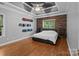 This spacious bedroom boasts hardwood floors, accent wall, tray ceiling and a fan at 2213 Normandin Ct, Charlotte, NC 28216