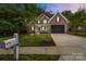 Charming brick home with well-manicured lawn and beautiful landscaping at 2213 Normandin Ct, Charlotte, NC 28216