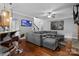 Inviting living room with hardwood floors, media display, and open layout to the kitchen at 2213 Normandin Ct, Charlotte, NC 28216