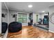 Bright workout room with wood floors, large mirror, fitness equipment and natural light at 2213 Normandin Ct, Charlotte, NC 28216