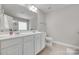 Bright bathroom featuring a double vanity with white cabinets and modern fixtures at 244 River Clay Rd, Fort Mill, SC 29708