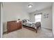 Cozy bedroom with carpet, wood furnishings, and natural light from the window at 244 River Clay Rd, Fort Mill, SC 29708