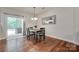 Bright dining room with hardwood floors, a sliding glass door, and seating for four at 244 River Clay Rd, Fort Mill, SC 29708