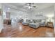 Open-concept living room with hardwood floors, a large sectional, and a dining area at 244 River Clay Rd, Fort Mill, SC 29708