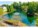 Beautiful aerial view of a pond with fountain and surrounding trees in the community at 244 River Clay Rd, Fort Mill, SC 29708