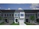 Charming townhouse featuring a one-car garage, a black front door, and light green siding at 2708 Lehigh Rd, Charlotte, NC 28208