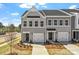 Charming gray townhouse with a one-car garage, well-manicured lawn, and inviting curb appeal at 2712 Lehigh Rd, Charlotte, NC 28208