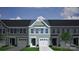 Charming exterior elevation of a modern townhome with green siding, white trim, and attached garage at 2712 Lehigh Rd, Charlotte, NC 28208