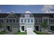 Charming townhome exterior features a garage and covered entrance with a beautiful blue-green facade at 2716 Lehigh Rd, Charlotte, NC 28208