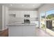 Modern kitchen featuring white cabinets, granite countertops, stainless steel appliances, and an island at 2720 Lehigh Rd, Charlotte, NC 28208