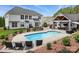 Beautiful backyard showcasing a swimming pool, an outdoor kitchen, and a well-maintained yard at 2763 Rivendale Ct, Indian Land, SC 29707