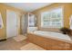A bright bathroom with a glass-enclosed shower, tiled walls, and a luxurious soaking tub, creating a spa-like experience at 2763 Rivendale Ct, Indian Land, SC 29707