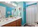 Bright bathroom features blue walls, a double sink vanity, and shower and tub at 2763 Rivendale Ct, Indian Land, SC 29707