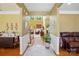 Bright foyer featuring hardwood floors, decorative rug, plant, white wainscoting, and views into the adjacent living spaces at 2763 Rivendale Ct, Indian Land, SC 29707