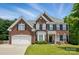 Traditional two-story brick home featuring black shutters, bay window, well-kept lawn, and an attached two-car garage at 2763 Rivendale Ct, Indian Land, SC 29707