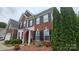 Charming brick home with black shutters, an American flag, and well-maintained landscaping in the front yard at 2763 Rivendale Ct, Indian Land, SC 29707