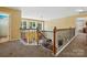 Second story hallway featuring wooden railing and railing, and views of the living room below at 2763 Rivendale Ct, Indian Land, SC 29707