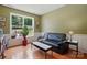 A cozy living room with hardwood flooring, a comfortable couch, and a view of the yard at 2763 Rivendale Ct, Indian Land, SC 29707