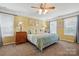 A bright main bedroom with carpet floors, ceiling fan, and plenty of natural light at 2763 Rivendale Ct, Indian Land, SC 29707