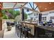 Well-equipped outdoor bar area with seating, adjacent to the backyard and covered living space at 2763 Rivendale Ct, Indian Land, SC 29707