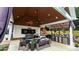 Covered outdoor kitchen with American Flag, seating and grilling area with easy access to the swimming pool at 2763 Rivendale Ct, Indian Land, SC 29707