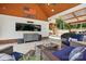 Covered outdoor living area with seating, large screen TV, and workspace at 2763 Rivendale Ct, Indian Land, SC 29707