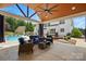 Relaxing covered patio features comfortable seating and a view of the backyard and pool at 2763 Rivendale Ct, Indian Land, SC 29707