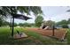 Community playground with swings, a covered seating area and play structures at 2763 Rivendale Ct, Indian Land, SC 29707