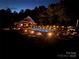 A serene night view showcasing a lit in-ground pool, creating a tranquil and inviting outdoor ambiance at 2763 Rivendale Ct, Indian Land, SC 29707