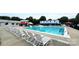 A sparkling pool with a slide, set against a backdrop of lounge chairs, offers a refreshing and fun aquatic experience at 2763 Rivendale Ct, Indian Land, SC 29707