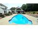 Sparkling in-ground pool with an outdoor kitchen, dining, and lounge area, perfect for entertaining at 2763 Rivendale Ct, Indian Land, SC 29707