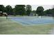 Community tennis court surrounded by green space and playground at 2763 Rivendale Ct, Indian Land, SC 29707