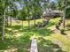 Spacious backyard featuring a wooden walkway leading towards a home with a rear deck at 2845 Lakefront Dr, Belmont, NC 28012