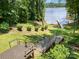 Inviting backyard featuring multi-tiered wooden decks with beautiful lake views at 2845 Lakefront Dr, Belmont, NC 28012