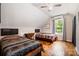 Charming bedroom with twin beds, hardwood floors, natural light, and a ceiling fan at 2845 Lakefront Dr, Belmont, NC 28012