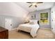 Bedroom featuring carpet floors, a ceiling fan, a window, and closet with a bi-fold door at 2845 Lakefront Dr, Belmont, NC 28012