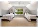 Bright bedroom featuring two twin beds, natural light, and charming leaf artwork at 2845 Lakefront Dr, Belmont, NC 28012