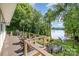 Inviting deck with lake views, wooden railing, steps down to lawn, seating, and grill create an ideal outdoor retreat at 2845 Lakefront Dr, Belmont, NC 28012