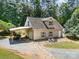 Inviting home exterior featuring a boat cover, gravel driveway, well-maintained landscaping, and a cozy front porch area at 2845 Lakefront Dr, Belmont, NC 28012