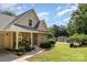 Charming stone and siding home with well-manicured front yard and covered porch offers inviting curb appeal at 2845 Lakefront Dr, Belmont, NC 28012