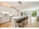 Bright, modern kitchen with white cabinets, stainless steel appliances, island with seating, and hardwood floors at 2845 Lakefront Dr, Belmont, NC 28012