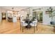 Open-concept kitchen and dining area featuring white cabinets, a modern island, and a view of the screened porch at 2845 Lakefront Dr, Belmont, NC 28012