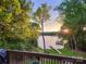 Sunset view of the lake featuring a dock and a serene environment surrounded by lush trees at 2845 Lakefront Dr, Belmont, NC 28012