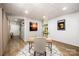Functional office area showcasing hardwood floors, shiplap walls, and an open layout leading to a dining area at 2845 Lakefront Dr, Belmont, NC 28012
