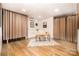 Bright office space featuring a sleek desk, neutral decor, hardwood floors, and a unique curtain room divider at 2845 Lakefront Dr, Belmont, NC 28012