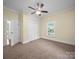 Bedroom featuring carpet floors, a ceiling fan, a closet, and a window overlooking the neighborhood at 300 W 12Th St, Salisbury, NC 28144