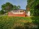 Back exterior featuring a deck with stairs and a grassy lawn at 300 W 12Th St, Salisbury, NC 28144