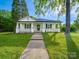 Charming home with a welcoming front porch and well-manicured lawn, perfect for relaxing outdoors at 300 W 12Th St, Salisbury, NC 28144