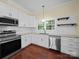 Bright kitchen features stainless steel appliances, white cabinets, and granite countertops at 300 W 12Th St, Salisbury, NC 28144